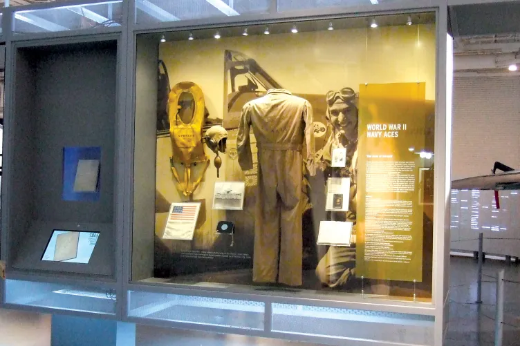 A display case showing a uniform with the headline that reads "World War II Navy Aces"