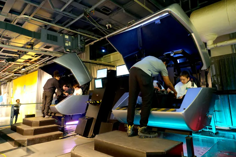 G Force capsules with visitors about to start ride