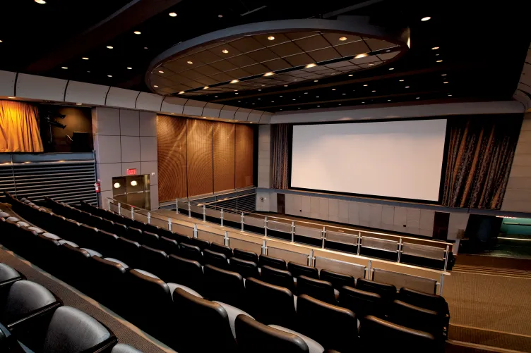 Photo of the theater with a  large screen in the background
