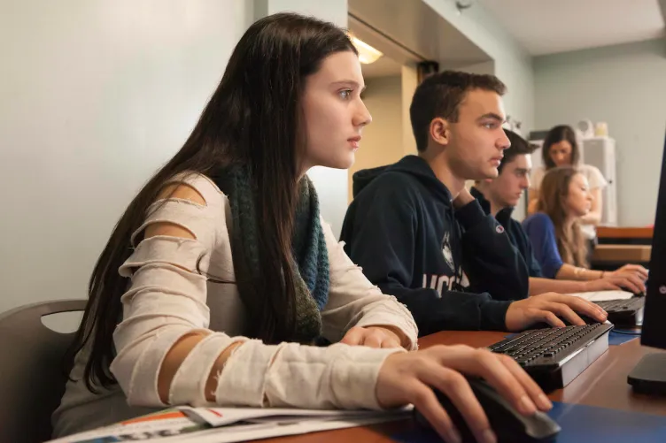 A group of young people working on computers.