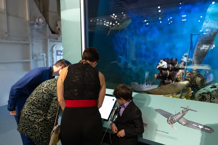 Museum visitors engaging with the Final Flight: The Story of a WWII Corsair exhibit.