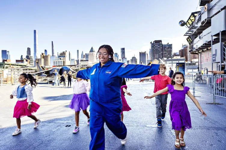Birthday party enjoying an activity on the flight deck of the Intrepid Museum.