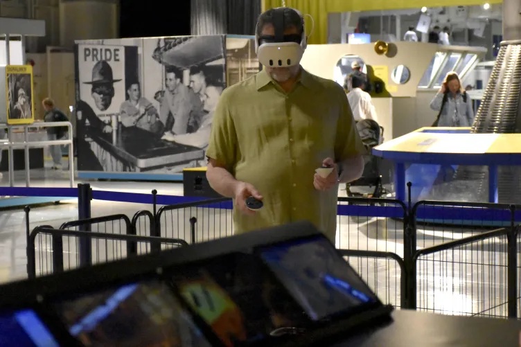 Guest explores the Intrepid's engine room through an immersive VR experience