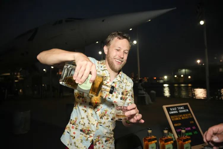 A man pouring a shot of liquor.