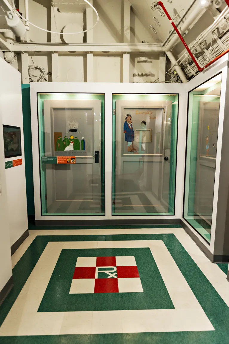 Part of the sick bay exhibition with sailor art on the floor.