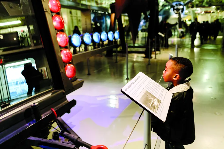 A young boy is looking at the official landing system.