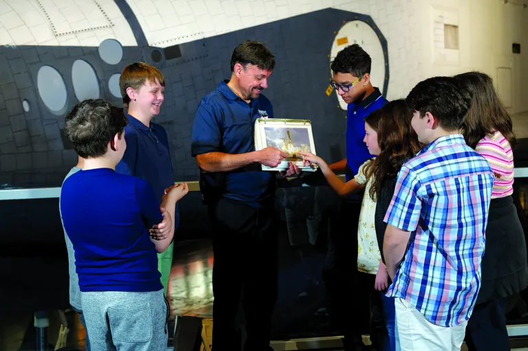 A Museum educator with a group of students