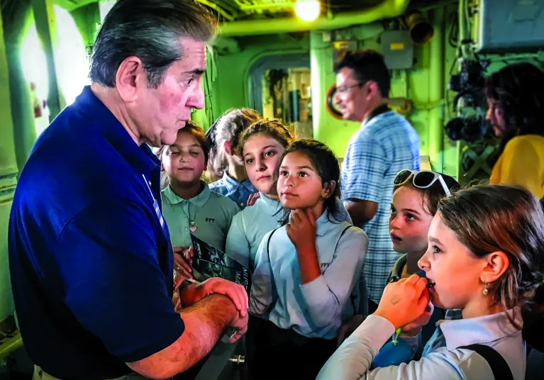 A volunteer talking to a group of girls