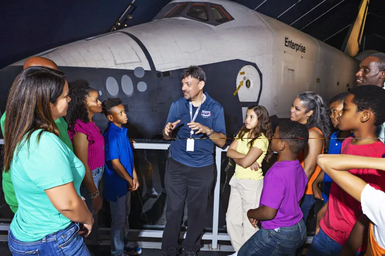 Visitors take part in a guided tour inside the Space Shuttle Pavilion at the museum.