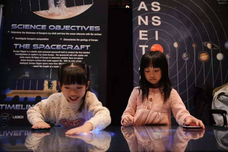 Two children learning about space during Kids Week