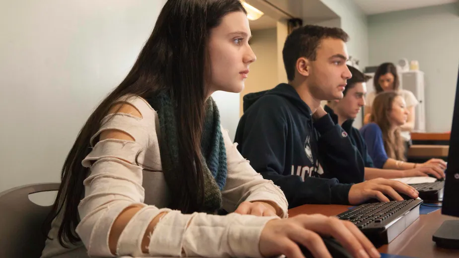 A group of young people working on computers.