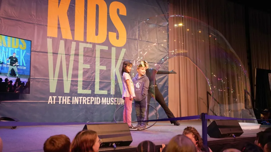 A Kids Week activity featuring a bubble balloon show on stage."