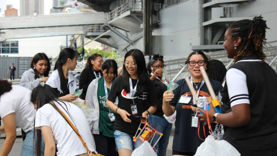 A group of young students engaged in hands-on STEM activities during Space Day at the Intrepid Museum.