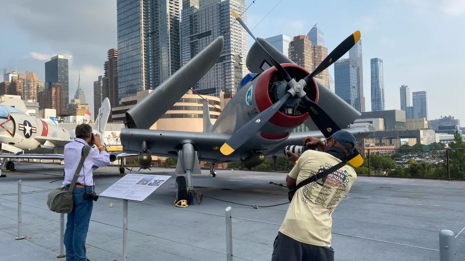 Patrons taking photos of aircraft on Intrepid's flight deck.